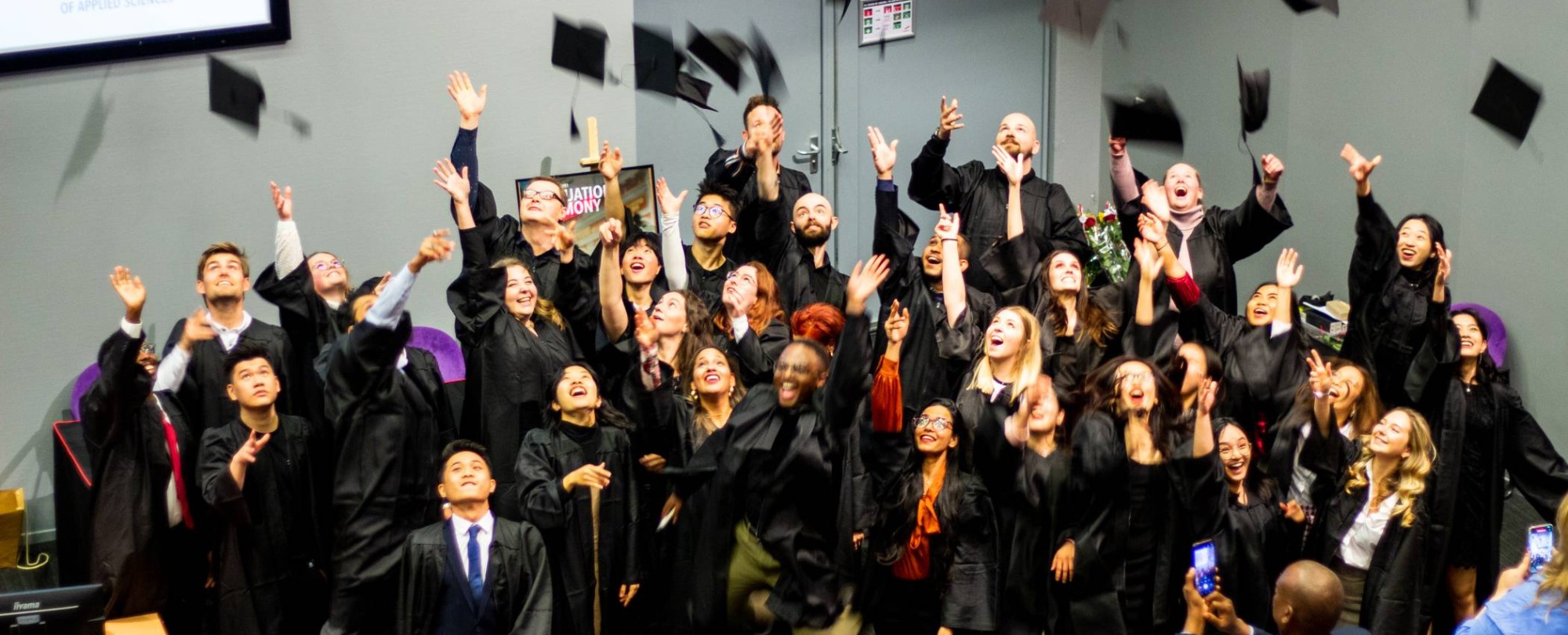 The picture shows the throwing of the hat by ISB graduates.