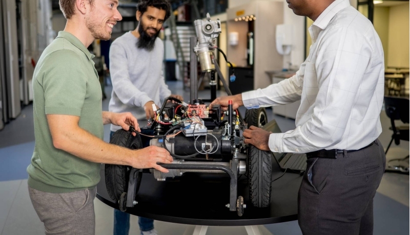 Een docent en twee studenten van de Master Engineering Systems Cyber Physical Systems werken aan het MORE-project, de scootmobiel.
