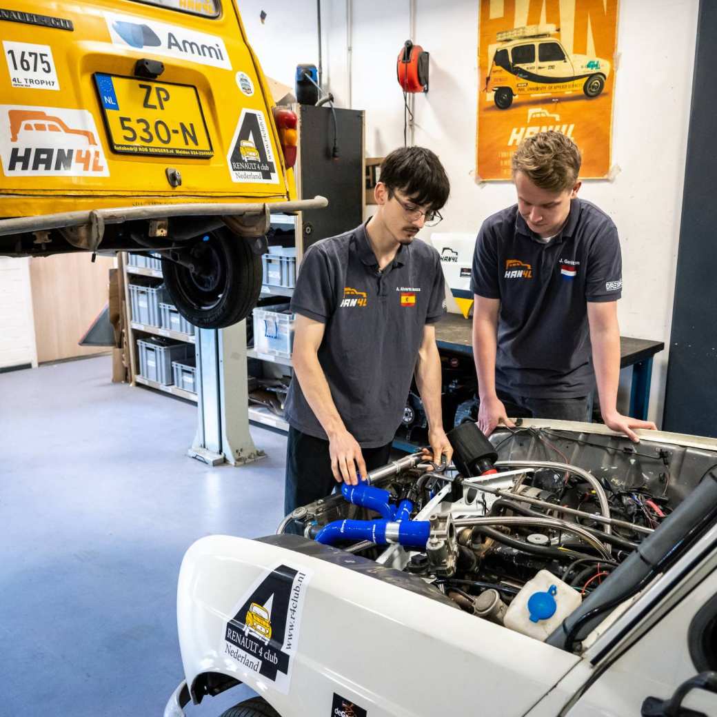 Students Alex and Jasper inspect one of the Renault 4L vehicles