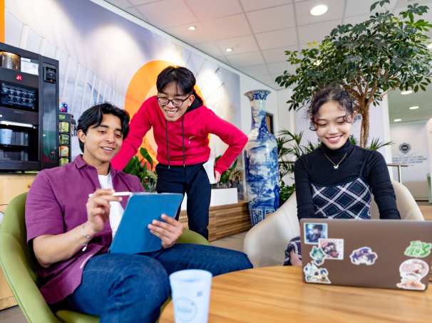 International students Diego, Patrick and Tam studying in the lounge on the Arnhem campus, building R31. 