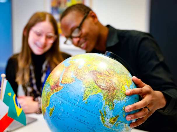 Studenten draaien aan wereldbol